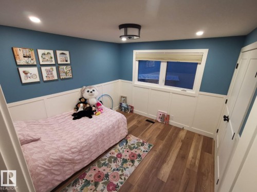 Room featuring wood-finish flooring, recessed lighting, and a contemporary flush-mount ceiling fixture - 12423 28A Avenue, Edmonton, AB - Indoor Photo Showing Bedroom