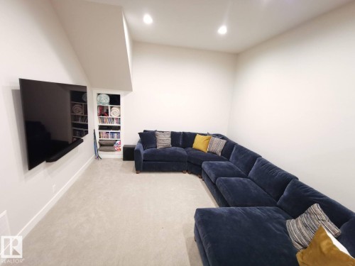 Recessed lighting illuminates this room featuring wall-to-wall carpeting and a built-in shelving unit - 12423 28A Avenue, Edmonton, AB - Indoor