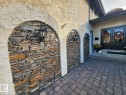 Stucco exterior with stone veneer arched accents and exterior wall lanterns - 12423 28A Avenue, Edmonton, AB  - Outdoor 