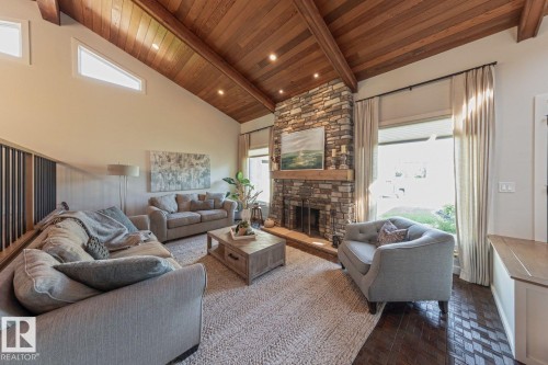 Vaulted wood-finish ceiling with exposed beams - 12423 28A Avenue, Edmonton, AB - Indoor Photo Showing Living Room With Fireplace
