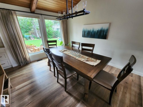 Dining area featuring wood-finish flooring and a wood-paneled vaulted ceiling with exposed beams - 12423 28A Avenue, Edmonton, AB - Indoor Photo Showing Dining Room