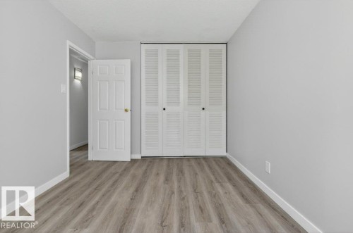 Light gray wall color complementing the wood-finish flooring - 3E Twin Terrace, Edmonton, AB - Indoor Photo Showing Other Room