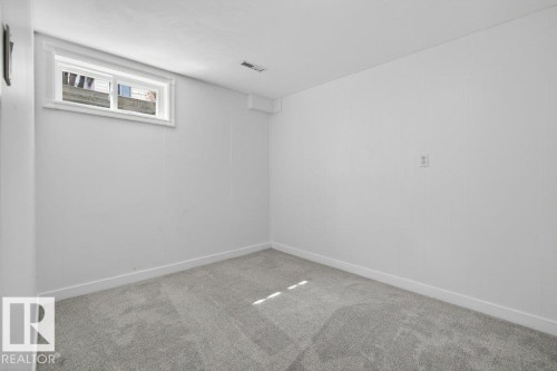 Recessed window with white trim, light gray wall-to-wall carpeting, white painted walls, white baseboards, and a ceiling-mounted ventilation register - 3E Twin Terrace, Edmonton, AB - Indoor Photo Showing Other Room
