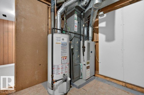 Utility area featuring a water heater, furnace, and exposed ductwork - 3E Twin Terrace, Edmonton, AB - Indoor Photo Showing Basement