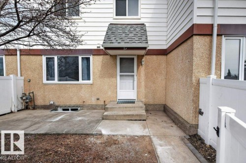 Entryway featuring a white storm door, concrete steps, and protective awning - 3E Twin Terrace, Edmonton, AB - Outdoor With Exterior