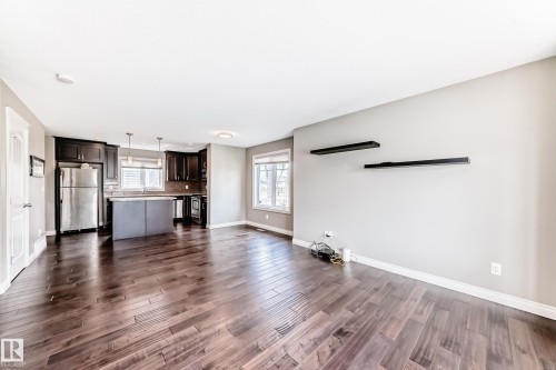Open-concept living space with dark wood-finish flooring - 10519 114 Avenue, Edmonton, AB - Indoor