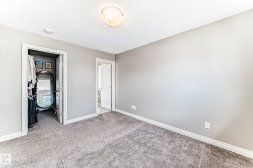 Spacious interior room featuring light gray wall paint, textured ceiling, and gray carpet flooring - 10519 114 Avenue, Edmonton, AB - Indoor Photo Showing Other Room