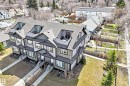 Modern townhome exterior with dormer windows, stone veneer accents, individual front entrances, and private balconies - 10519 114 Avenue, Edmonton, AB  - Outdoor 
