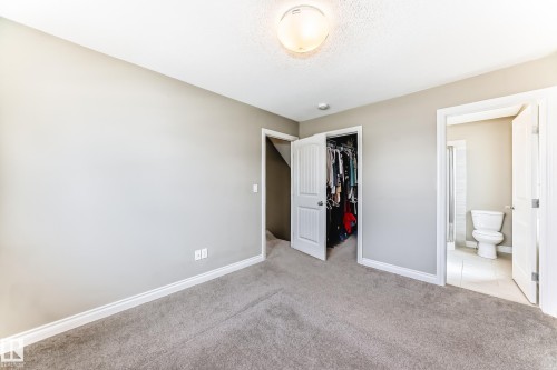 Carpeted room featuring a white ceiling, overhead flush-mount lighting, and light gray wall paint - 10519 114 Avenue, Edmonton, AB - Indoor Photo Showing Other Room