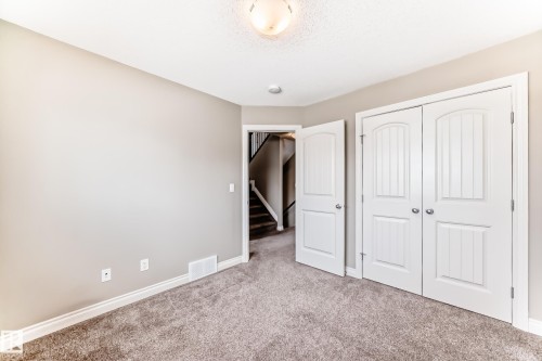 Carpeted interior room featuring light gray wall paint, white baseboards, and white trim around doorways - 10519 114 Avenue, Edmonton, AB - Indoor