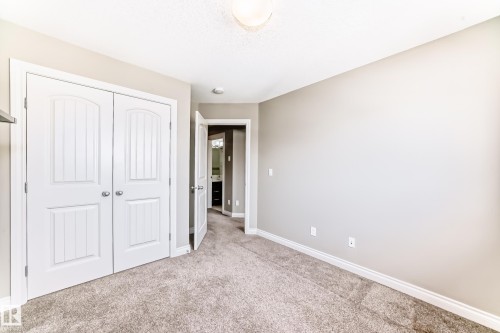 Neutral-toned room featuring a soft carpeted floor and white baseboards - 10519 114 Avenue, Edmonton, AB - Indoor Photo Showing Other Room
