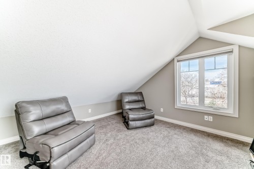 Carpeted room with sloped ceilings and a double-hung window - 10519 114 Avenue, Edmonton, AB - Indoor