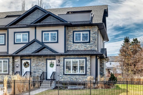 Modern multi-level exterior featuring stone veneer, horizontal siding, and dark trim accents - 10519 114 Avenue, Edmonton, AB - Outdoor With Facade