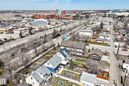 Aerial perspective showcasing multiple residential structures with pitched roofs - 10519 114 Avenue, Edmonton, AB - Outdoor With View