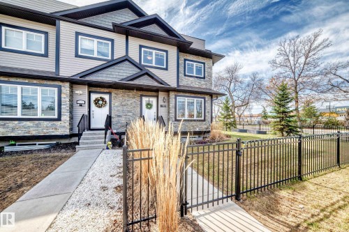 Modern multi-level exterior featuring stacked stone accents and neutral siding - 10519 114 Avenue, Edmonton, AB - Outdoor