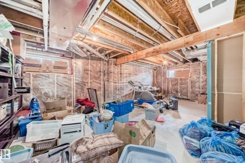 Unfinished basement featuring exposed wood joists, structural beams, and visible insulation - 10519 114 Avenue, Edmonton, AB - Indoor Photo Showing Basement
