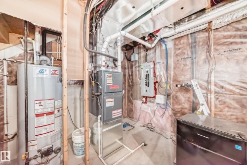 Utility area featuring a water heater, furnace, and electrical panel - 10519 114 Avenue, Edmonton, AB - Indoor Photo Showing Basement