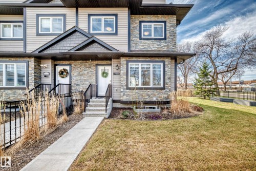 Stone veneer and siding exterior with dark trim accents - 10519 114 Avenue, Edmonton, AB - Outdoor With Facade