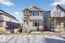 The property features a multi-toned exterior with siding and decorative shingles, a prominent front entrance with stairs, and multiple windows providing natural light - 1778 25A Street, Edmonton, AB  - Outdoor With Facade 