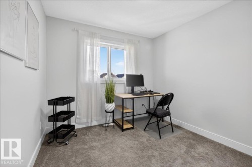 This room features light-colored walls and grey carpet flooring - 1778 25A Street, Edmonton, AB - Indoor Photo Showing Office