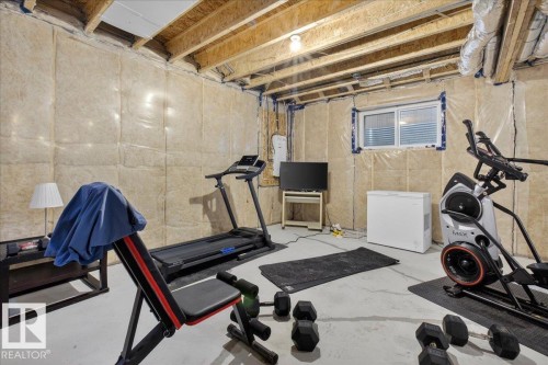 The property features an unfinished basement with exposed ceiling joists and visible insulation - 1778 25A Street, Edmonton, AB - Indoor Photo Showing Basement