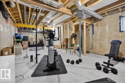 The property features a spacious unfinished basement with exposed wooden beams, ductwork, and insulation on the walls, offering significant potential - 1778 25A Street, Edmonton, AB - Indoor Photo Showing Basement