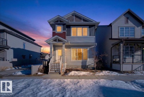 The property features a multi-level facade with visible window trim detailing and a front porch with stairs leading to the entrance - 1778 25A Street, Edmonton, AB - Outdoor With Facade