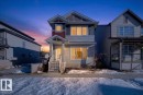 The property features a multi-level facade with visible window trim detailing and a front porch with stairs leading to the entrance - 1778 25A Street, Edmonton, AB  - Outdoor With Facade 