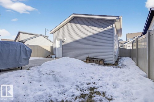 The property includes a detached garage with light-colored siding and a side entry door - 1778 25A Street, Edmonton, AB - Outdoor With Exterior