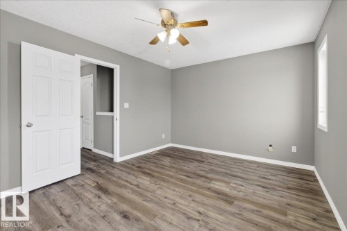 Unfurnished bedroom featuring wood finished floors, ceiling fan, and a textured ceiling - 150 Acacia Circle, Leduc, AB - Indoor Photo Showing Other Room