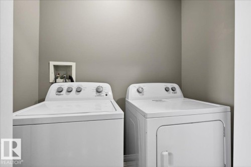 Laundry room with washing machine and dryer - 150 Acacia Circle, Leduc, AB - Indoor Photo Showing Laundry Room