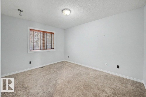 This room features light grey walls, a window with wooden blinds, and carpeted flooring - Edmonton, AB - Indoor Photo Showing Other Room
