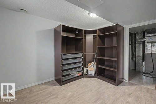 This space offers built-in shelving and drawers, providing storage solutions - Edmonton, AB - Indoor