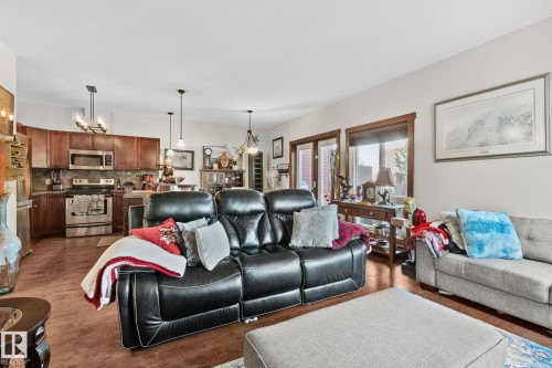 Open-concept living space featuring wood-finish flooring - 2201 Graybriar Green, Stony Plain, AB - Indoor Photo Showing Living Room