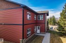 Red horizontal siding exterior with black trim and white-framed windows - 2201 Graybriar Green, Stony Plain, AB  - Outdoor With Exterior 