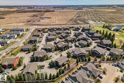 Aerial view showcasing a residential community with varied architectural styles and mature evergreen landscaping - 2201 Graybriar Green, Stony Plain, AB - Outdoor With View
