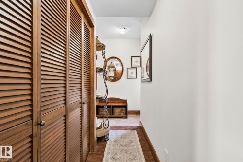 Louvered wood-finish closet doors, wood-finish baseboards, and a recessed ceiling light - 2201 Graybriar Green, Stony Plain, AB - Indoor Photo Showing Other Room