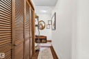 Louvered wood-finish closet doors, wood-finish baseboards, and a recessed ceiling light - 2201 Graybriar Green, Stony Plain, AB  - Indoor Photo Showing Other Room 