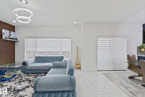 Open-concept living space featuring high ceilings, recessed lighting, and polished tile flooring - 1210 Peregrine Terrace, Edmonton, AB - Indoor Photo Showing Living Room