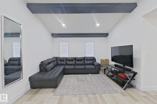 Living area featuring wood-finish flooring, recessed lighting, and white walls - 1210 Peregrine Terrace, Edmonton, AB - Indoor Photo Showing Living Room