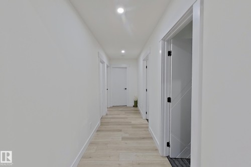 Bright hallway featuring wood-finish flooring and recessed ceiling lighting - 1210 Peregrine Terrace, Edmonton, AB - Indoor Photo Showing Other Room