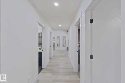 Hallway featuring recessed lighting, light wood-finish flooring, white walls, and white trim - 1210 Peregrine Terrace, Edmonton, AB - Indoor Photo Showing Other Room