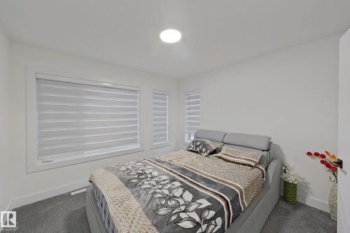 Bright bedroom featuring white walls, gray carpet, and two windows with horizontal blinds - 1210 Peregrine Terrace, Edmonton, AB - Indoor Photo Showing Bedroom