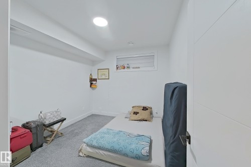 Interior room with light gray carpeting, white walls, and a single recessed ceiling light - 1210 Peregrine Terrace, Edmonton, AB - Indoor
