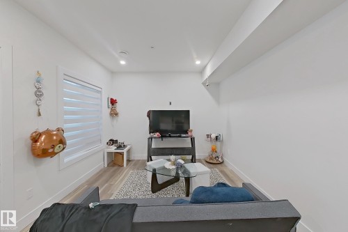 Living area with recessed lighting, light wood-finish flooring, and white walls - 1210 Peregrine Terrace, Edmonton, AB - Indoor
