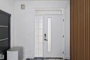 Entryway featuring a white door with a vertical frosted glass insert, an adjacent frosted sidelight with grid details, and a transom window above - 1210 Peregrine Terrace, Edmonton, AB  - Indoor Photo Showing Other Room 