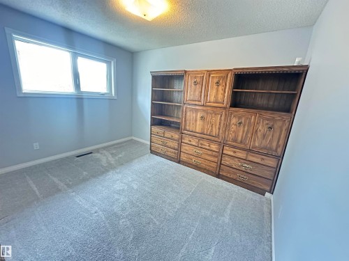 Built-in wood cabinetry unit with brass hardware - 11131 52 Street, Edmonton, AB - Indoor Photo Showing Other Room