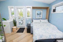 Integrated wall bed system with neutral-toned wood-finish flooring - 