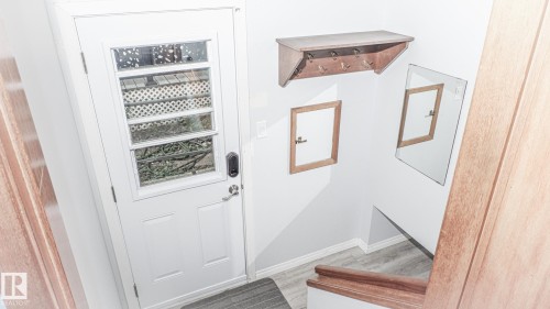 Entryway featuring a white door with multiple glass panes, a digital lock, and a matching door handle - 11131 52 Street, Edmonton, AB - Indoor Photo Showing Other Room