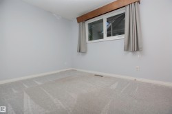 Light gray wall paint with white baseboards and gray patterned carpeting - 